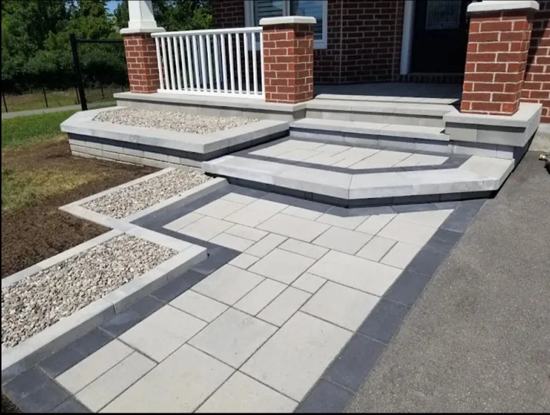 New interlocking paver walkway and steps with gravel beds leading to a home